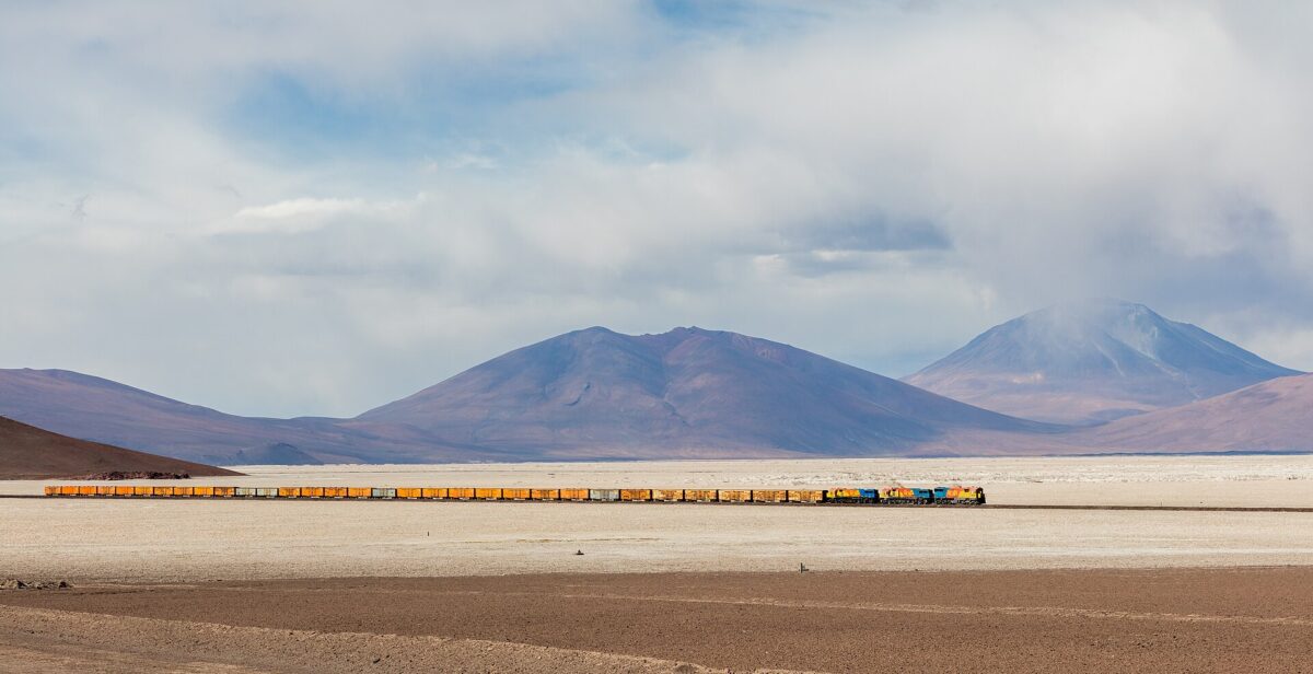 FCAB railway crossing the 35 kilometers (22 mi) long route over the west side of the Ascotán salt flat, southwestern Bolivia. The train c…