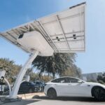 Electric car charging under a modern solar panel station, showcasing clean energy technology.
