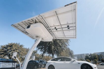 Electric car charging under a modern solar panel station, showcasing clean energy technology.