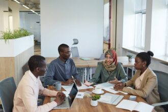 A diverse group of professionals engaging in a productive meeting in a contemporary office space.