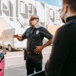 A police officer interacting with civilians during a peaceful protest in an urban setting.