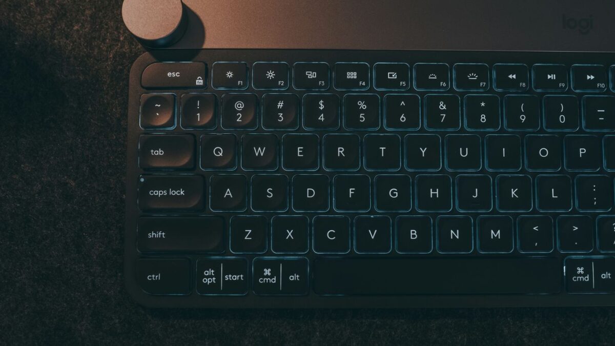 A computer keyboard sitting on top of a table