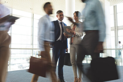 Front view of diverse business executives discussing over digital tablet in conference
