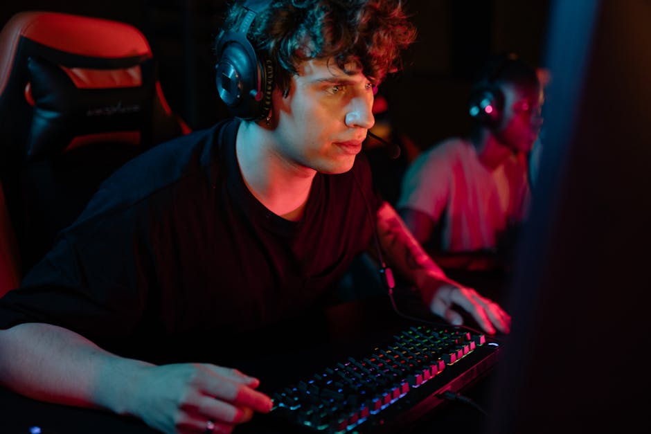 A dedicated gamer immersed in a gaming session with colorful lighting and headphones.