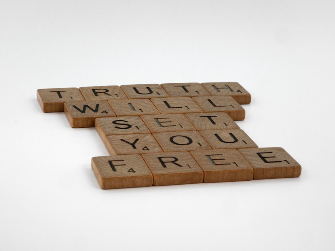 three scrabble tiles spelling truth and truth
