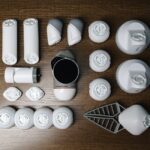 Assorted robotics parts arranged neatly on a wooden surface, showcasing innovative technology.