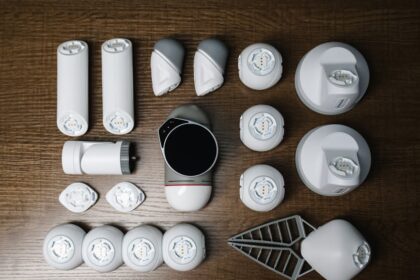 Assorted robotics parts arranged neatly on a wooden surface, showcasing innovative technology.