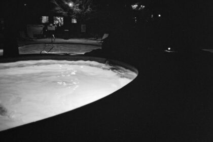 People swimming in a pool at night