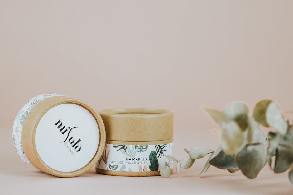 Organic skincare packaging with eucalyptus on a pastel background.