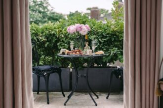 Charming outdoor table with peonies and wine, perfect for a summer brunch.