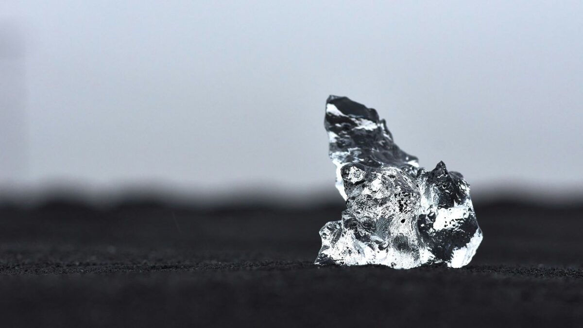 a piece of ice sitting on top of a black surface