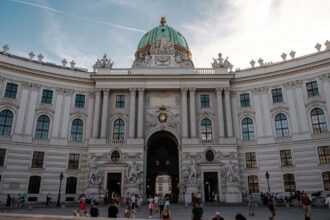 a group of people standing in front of a large building