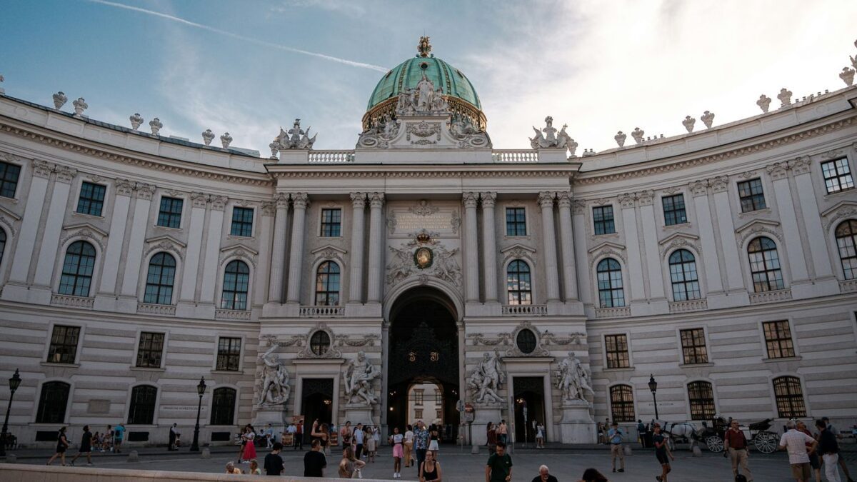a group of people standing in front of a large building