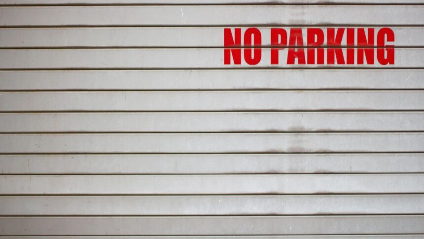 a no parking sign on a garage door