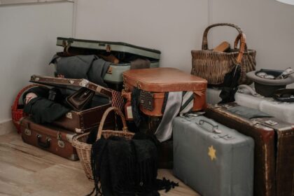 a pile of luggage sitting on top of a hard wood floor