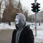 a person wearing a mask standing in the snow