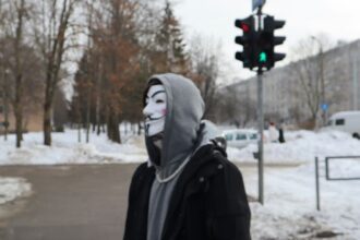a person wearing a mask standing in the snow