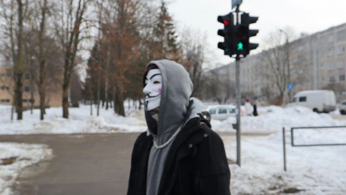 a person wearing a mask standing in the snow