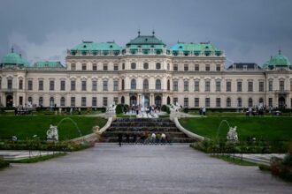 a large building with a fountain in front of it